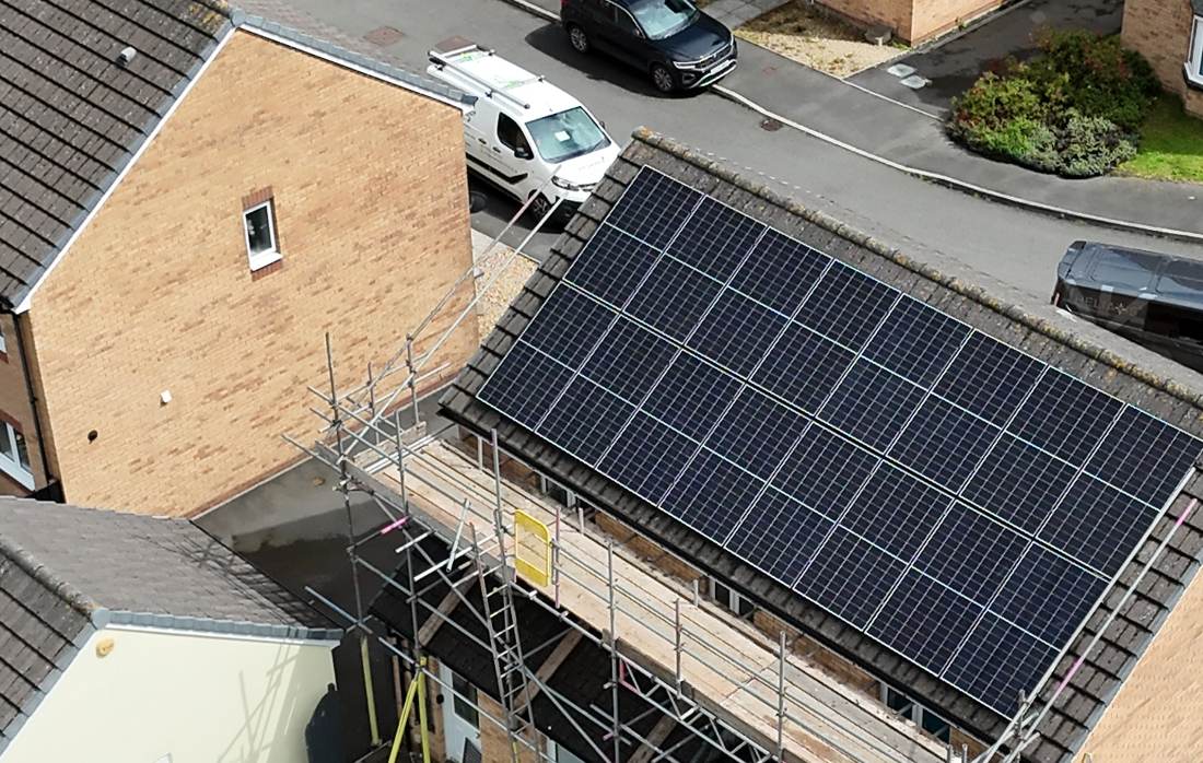 Close-up drone view of all-black solar panels on one of our installs